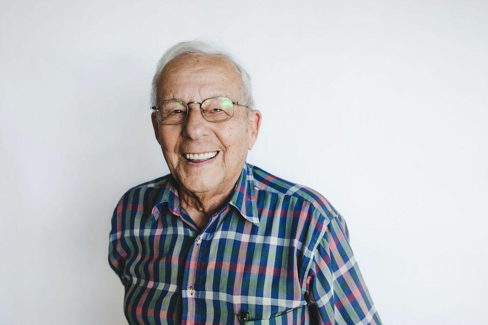 Happy Senior Man Looking At Camera On White Background
